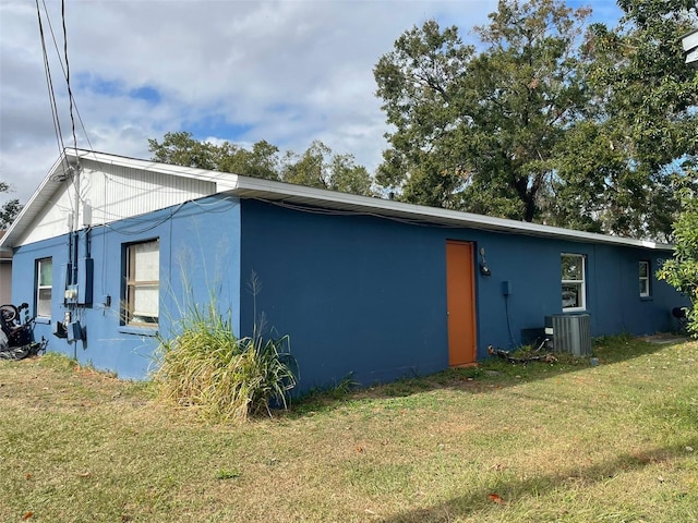 exterior space featuring a yard and central AC unit