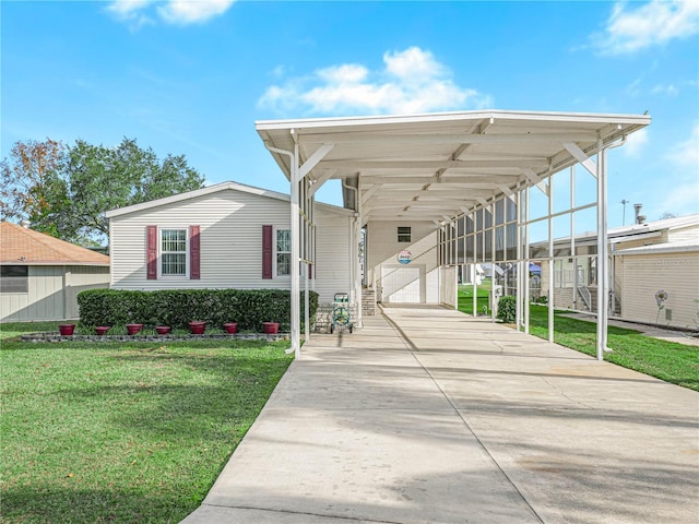 exterior space with a carport and a lawn