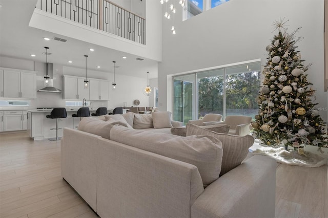 living room featuring light hardwood / wood-style floors and a high ceiling