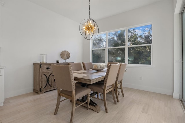 dining space with a chandelier and light wood-type flooring