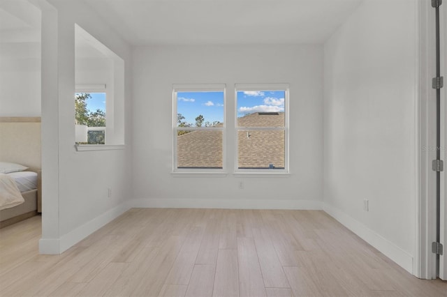 unfurnished room with light hardwood / wood-style flooring