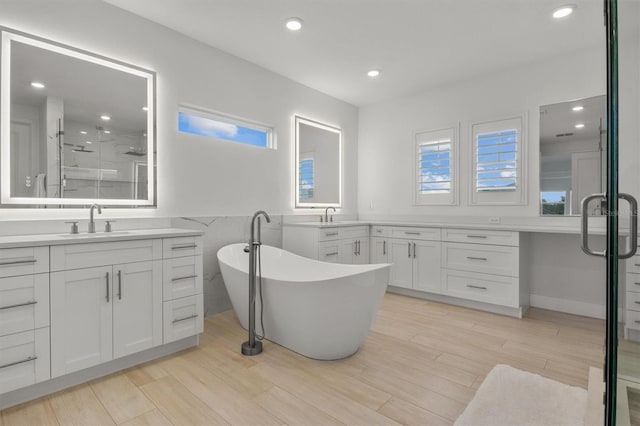 bathroom with vanity and independent shower and bath