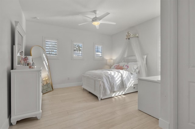 bedroom with ceiling fan and light hardwood / wood-style flooring