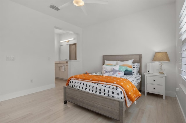 bedroom with connected bathroom, ceiling fan, and light hardwood / wood-style flooring