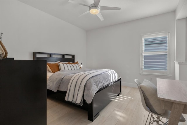 bedroom with ceiling fan and light hardwood / wood-style flooring