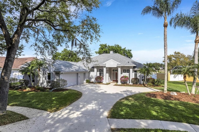 view of front of home with a garage and a front lawn