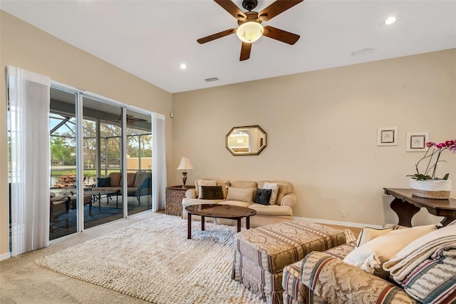 living room with ceiling fan and carpet floors