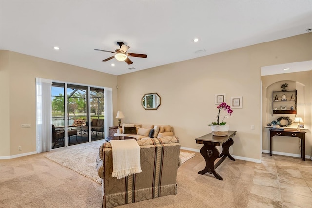 living room featuring ceiling fan and light carpet