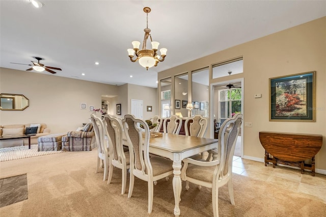 tiled dining room with ceiling fan with notable chandelier