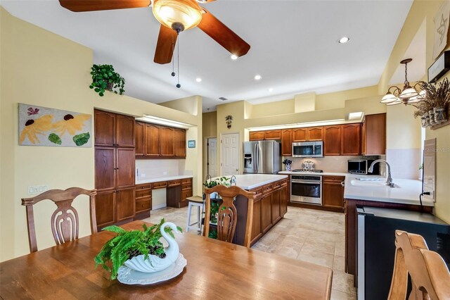 kitchen with ceiling fan with notable chandelier, sink, hanging light fixtures, light tile patterned flooring, and stainless steel appliances