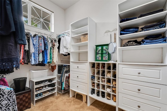 walk in closet featuring light carpet