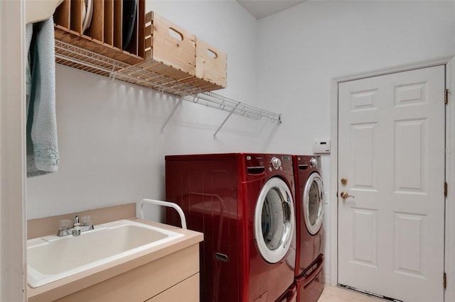 washroom with washer and dryer, light tile patterned floors, and sink