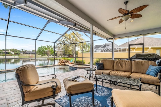 view of patio / terrace featuring ceiling fan, a pool with hot tub, a lanai, an outdoor living space, and a water view