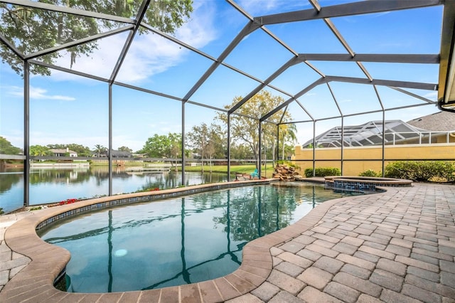 view of pool featuring an in ground hot tub, a patio, a water view, and glass enclosure