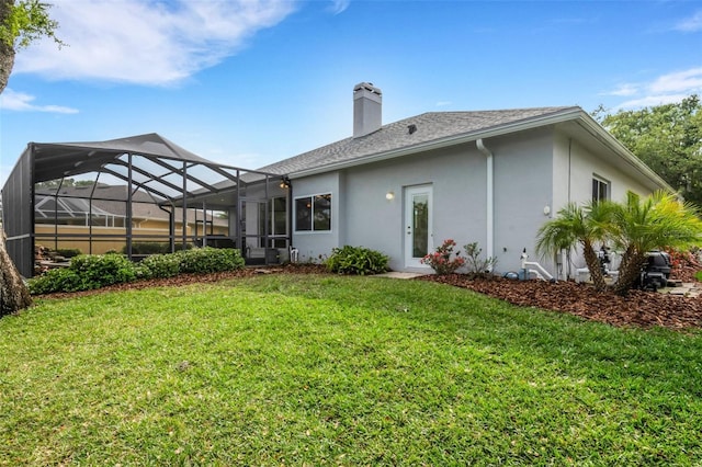 rear view of property featuring glass enclosure and a lawn