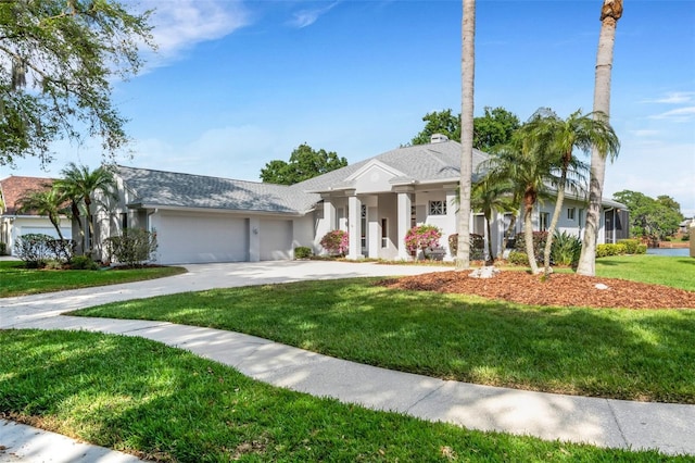 view of front of home featuring a garage and a front lawn