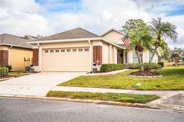 view of front of property with a garage and a front lawn