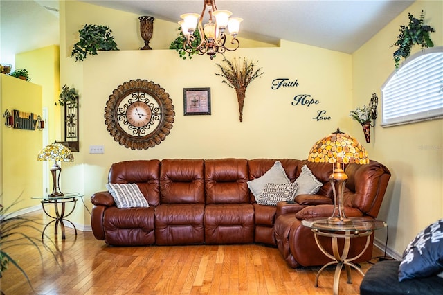 living room with hardwood / wood-style floors, vaulted ceiling, and a notable chandelier