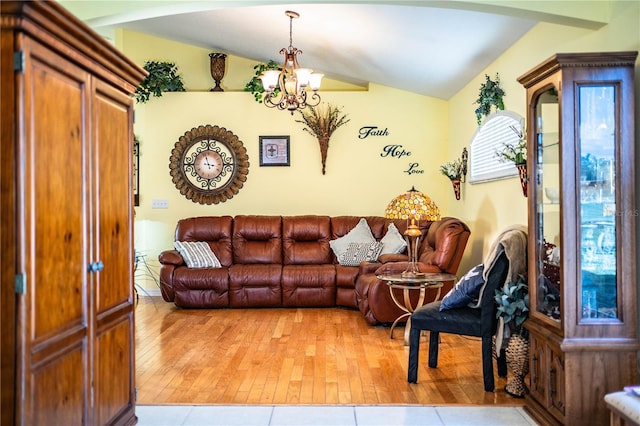 living room with light hardwood / wood-style flooring, vaulted ceiling, and a notable chandelier