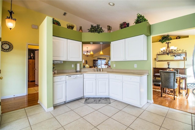 kitchen featuring white cabinets, pendant lighting, and white dishwasher