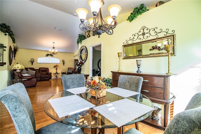 dining area with a notable chandelier and wood-type flooring