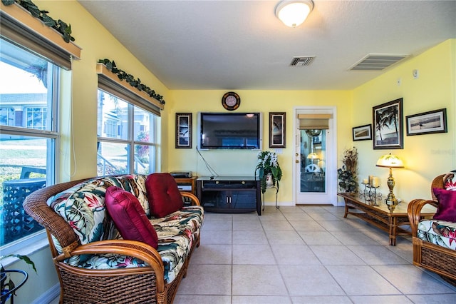 living room with light tile patterned floors and a textured ceiling