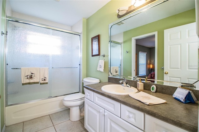 full bathroom with shower / bath combination with glass door, vanity, toilet, and tile patterned flooring