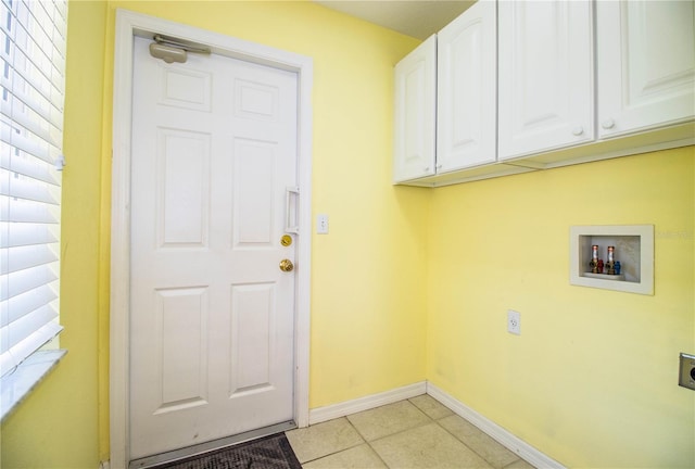 washroom featuring electric dryer hookup, light tile patterned floors, cabinets, and washer hookup