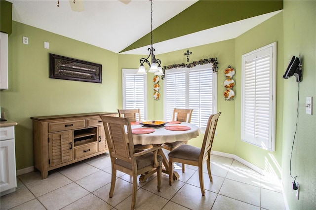 tiled dining space with vaulted ceiling