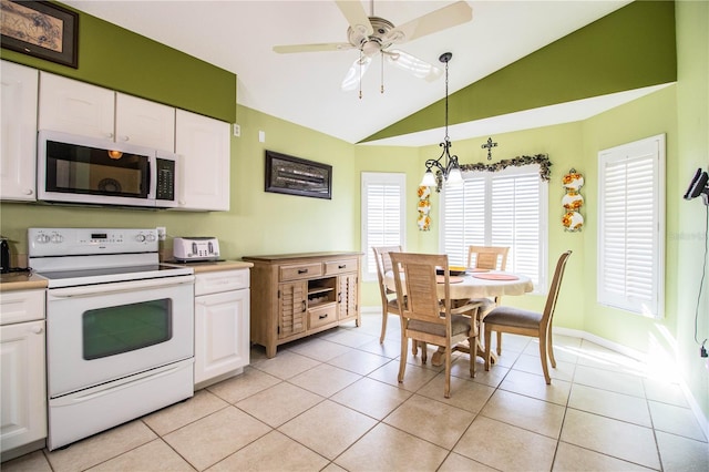 kitchen featuring white cabinets, white range with electric stovetop, light tile patterned floors, and hanging light fixtures