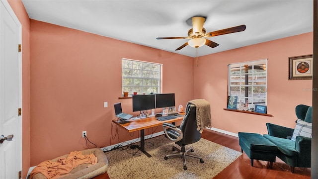 office space with hardwood / wood-style floors and ceiling fan