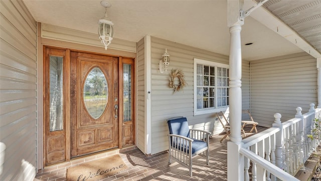 view of exterior entry featuring a porch