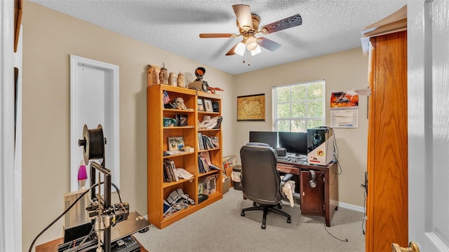 office area with ceiling fan, light colored carpet, and a textured ceiling