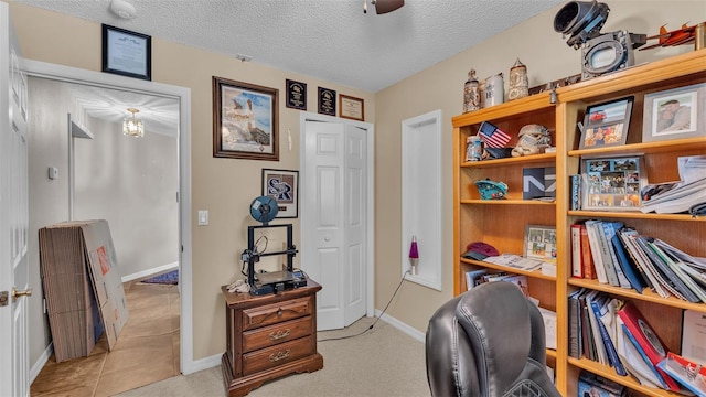 office with ceiling fan, light colored carpet, and a textured ceiling