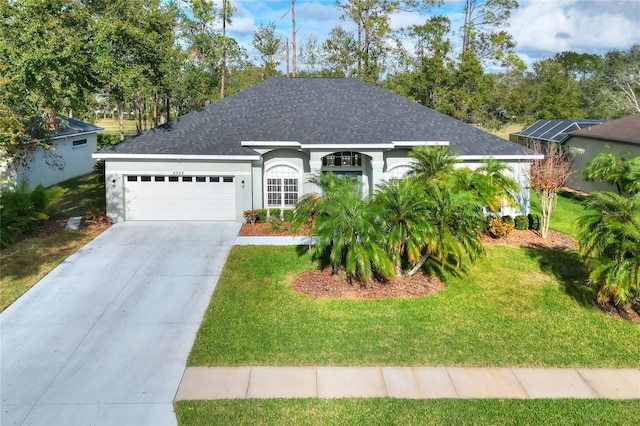 view of front of property with a front lawn and a garage