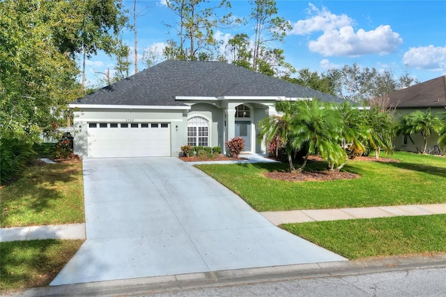 ranch-style house featuring a garage and a front lawn