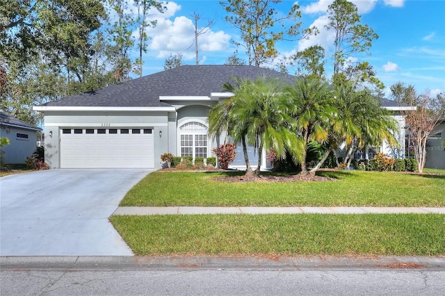 view of front of house featuring a garage and a front lawn