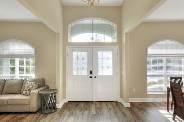 entryway featuring wood-type flooring and a chandelier