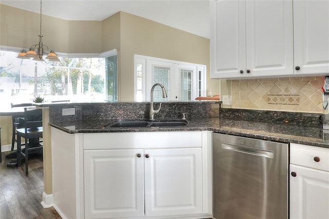 kitchen with sink, stainless steel dishwasher, dark stone counters, a chandelier, and white cabinets