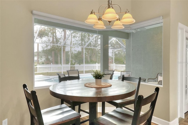 dining space with a wealth of natural light and an inviting chandelier