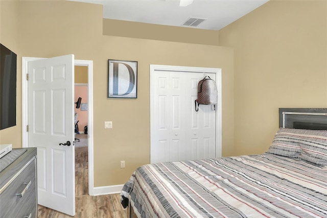 bedroom with light hardwood / wood-style floors, a closet, and ceiling fan