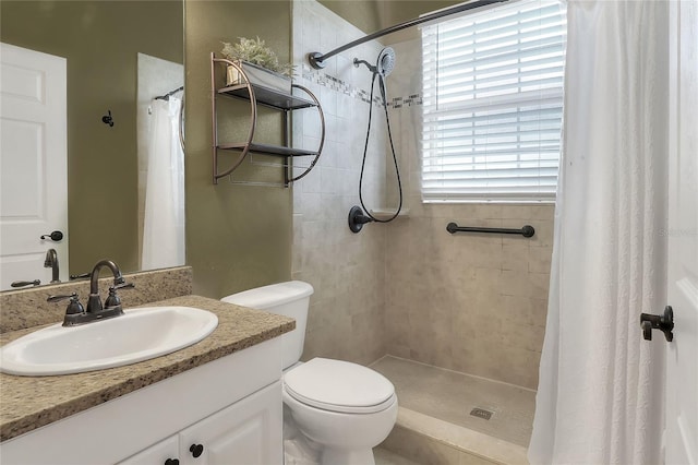 bathroom featuring vanity, toilet, and walk in shower