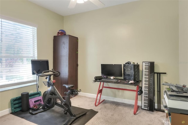 workout area with ceiling fan, light colored carpet, and a wealth of natural light