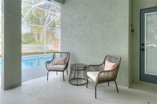 exterior space with a fenced in pool and glass enclosure