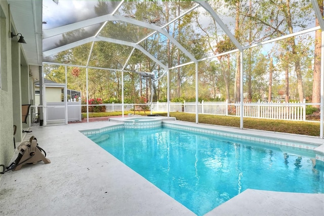 view of swimming pool featuring glass enclosure and a patio area