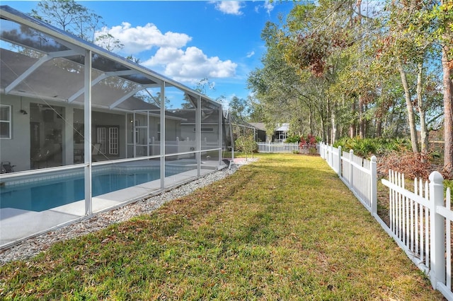 view of yard featuring a fenced in pool and glass enclosure