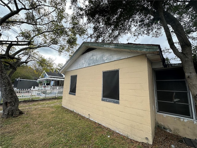 view of side of home with a yard