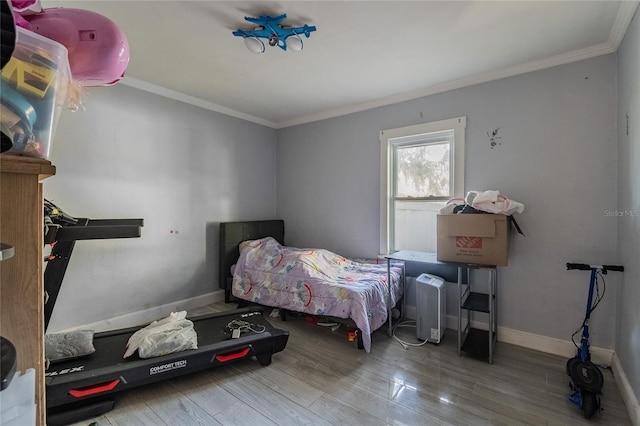 bedroom featuring hardwood / wood-style flooring and crown molding