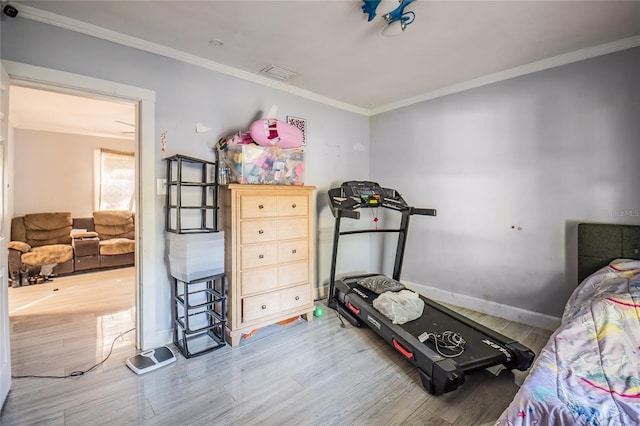 bedroom with hardwood / wood-style floors and ornamental molding