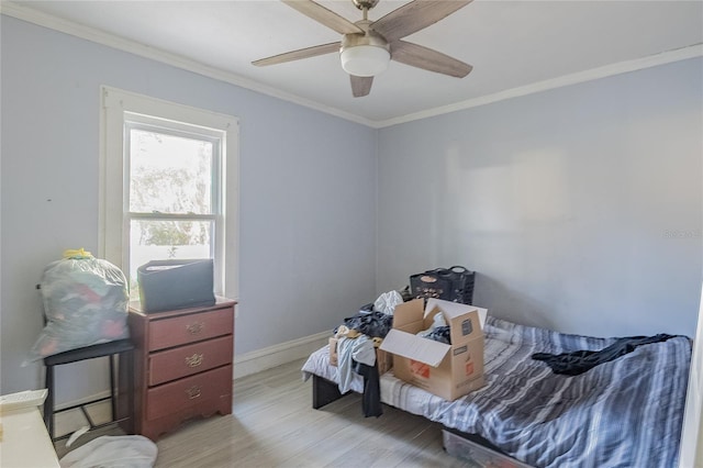 bedroom with ceiling fan, crown molding, and light hardwood / wood-style flooring